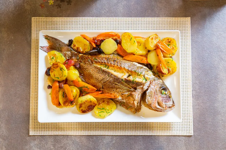 Whole gilthead with potatoes and vegetables